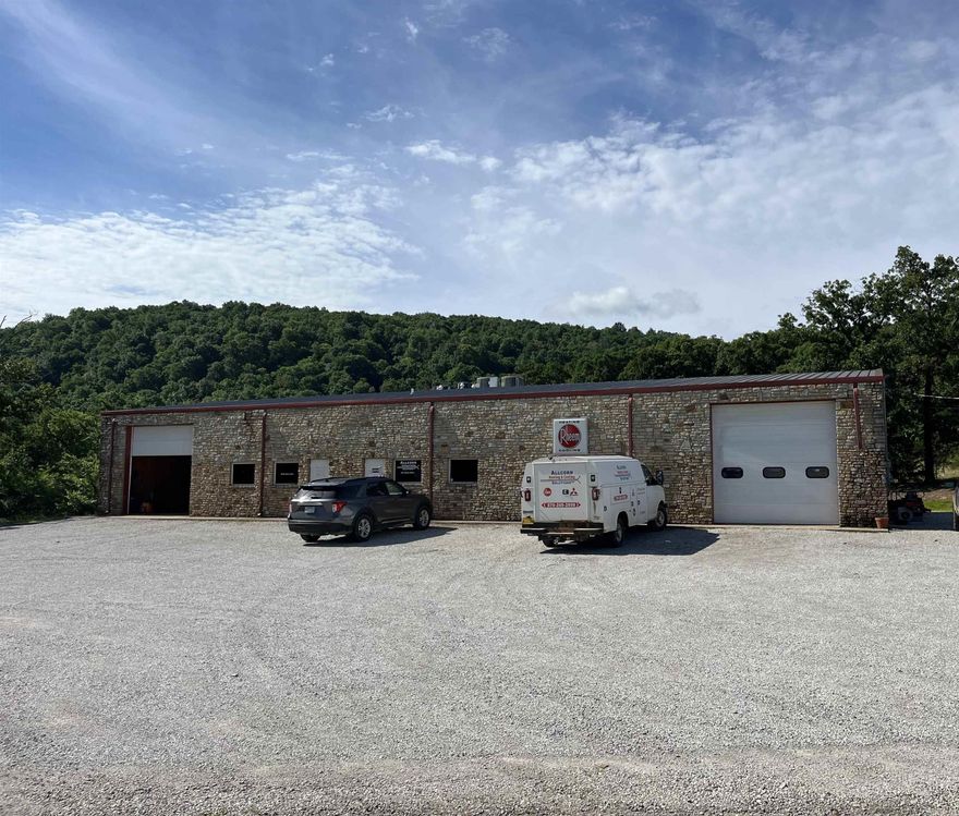 Commercial building located less than 3 miles from downtown Mountain View. It's a multi-use building built in 2007. There's approximately 6200 sq/ft under roof that sits on 2+/- acres. One side has a large shop area, paint room, break room and bathroom with storage above the office area. This side is heated. The other side has a large shop area and bathroom with storage above the office area. This side is heated/cooled. Each side has an office area which is also heated/cooled. Radiant heat in the floor is plumbed throughout the building. Three phase power is to the building! Each side has it's own electric meter so it could be separated if you choose to do that. Currently the entire building is running through one meter. Approximately 1/2 the building is being rented by a long-term renter.