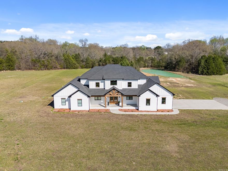 Private Drive, Safe Room, Hot Water Recirculation for Fast Hot Water, two dishwashers, EV charging infrastructure available for cars, insulated garage, chickens welcome, pump for extended warm water in jacuzzi tub & high speed fiber optic internet available!  Welcome to your dream estate — a stunning luxury residence perfectly blending elegance, comfort, and outdoor beauty on a private 3.12-acre sanctuary.  Step inside to discover grand high ceilings and expansive living spaces that radiate sophistication and openness. Every bedroom boasts spacious walk-in closets, providing abundant storage and organization. The heart of the home features a gourmet kitchen with premium finishes, TWO dishwashers and a double oven complemented by expansive natural light and seamless flow to living and entertaining areas. Relax and entertain year-round with a beautiful outdoor living area, complete with a custom outdoor fireplace, perfect for cool evenings and social gatherings. The property also includes a stocked pond, providing a perfect backdrop for outdoor enjoyment. You don't want to miss this one! Schedule a showing today for your private tour. Appraisal on file.