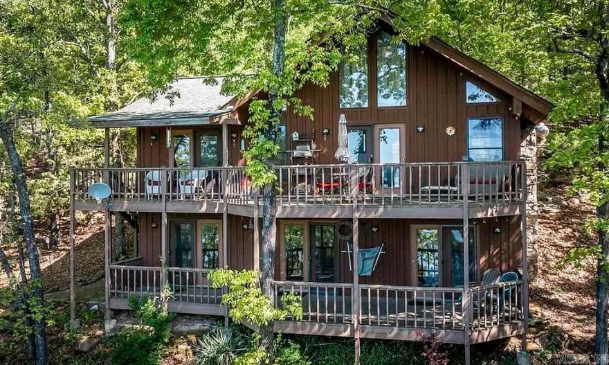 Rare opportunity to get direct lakefront access at an affordable price.  Stunning views from the 2 tiered deck on this amazing lakefront home.  No description of this house will do it justice.  You need to see it to believe it.  Included in the bedroom/bathroom count is an out building with a studio apartment.   This property is an established vacation rental, so you could help pay the bills by renting it when you are not there.