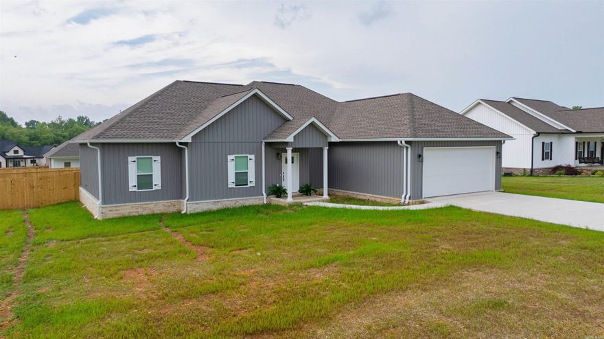 NEW CONSTRUCTION ! Built by Southern Touch Construction and completed earlier this year, this stunning 4-bedroom, 2-bath home in Buffalo Creek is a must-see! The open-concept layout seamlessly connects the living room, dining area, and kitchen offering generous space and natural light throughout.  Enjoy a private retreat in the split floor plan's primary suite, featuring a double vanity, spacious walk-in closet, separate soaking tub, and a beautifully tiled shower. Three additional well-sized bedrooms and a full bath provide comfort and versatility for family or guests.  Outside, the current owner has added thoughtful upgrades, including a wood privacy fence, gutters, and a sprinkler system enhancing both curb appeal and convenience.  Don't miss it!
