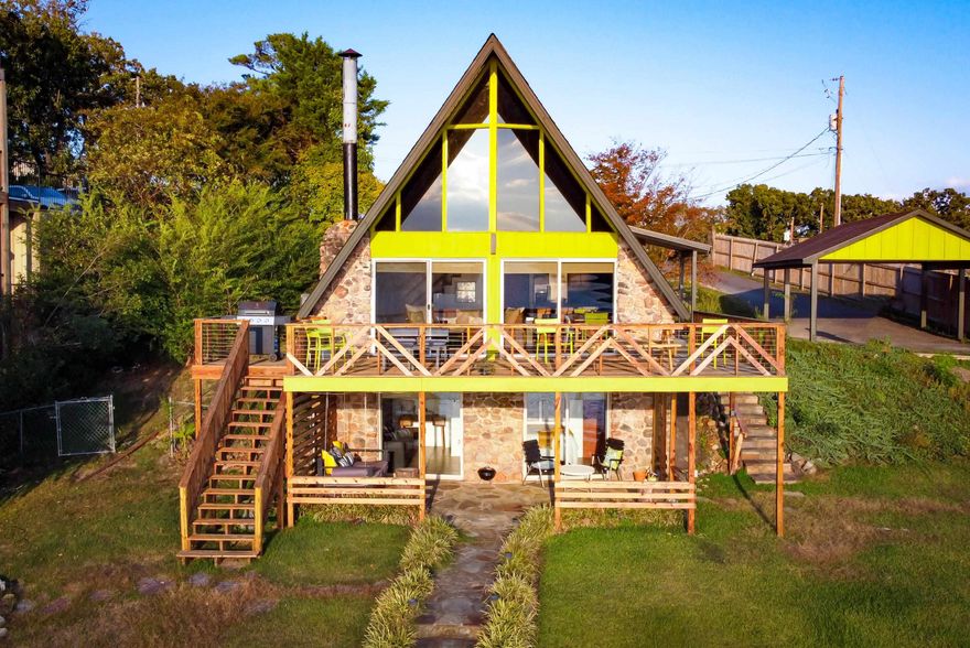 Welcome to this stunning A-frame 4-bedroom, 3.5-bathroom home that spans 1,456 sq ft and offers a private upper and lower deck, a 2-slip covered boat dock, and a fun water slide.  On the main level, you'll find Bedroom 1 with a full bathroom in the hallway. Bedroom 2 is the master bedroom with an en-suite master bathroom featuring a Jacuzzi Whirlpool tub and a separate walk-in shower. The main level also hosts a super comfortable sectional couch, a dining table for 6, and additional barstools for 4. The fully equipped kitchen includes an electric stove/oven combo, refrigerator, microwave, and a Keurig. The main upper deck offers beautiful views of the main channel of Lake Hamilton and can be accessed from two huge sliding glass doors.  Upstairs, you'll find Bedroom 3, a private closet, and a ½ bathroom. This level also features a private sitting area overlooking the living area downstairs.  The downstairs level features Bedroom 4 with private access to the bottom-level covered deck with a swinging porch bed. It also includes a full bathroom. There's also a kitchenette featuring a microwave, mini fridge, and Keurig.