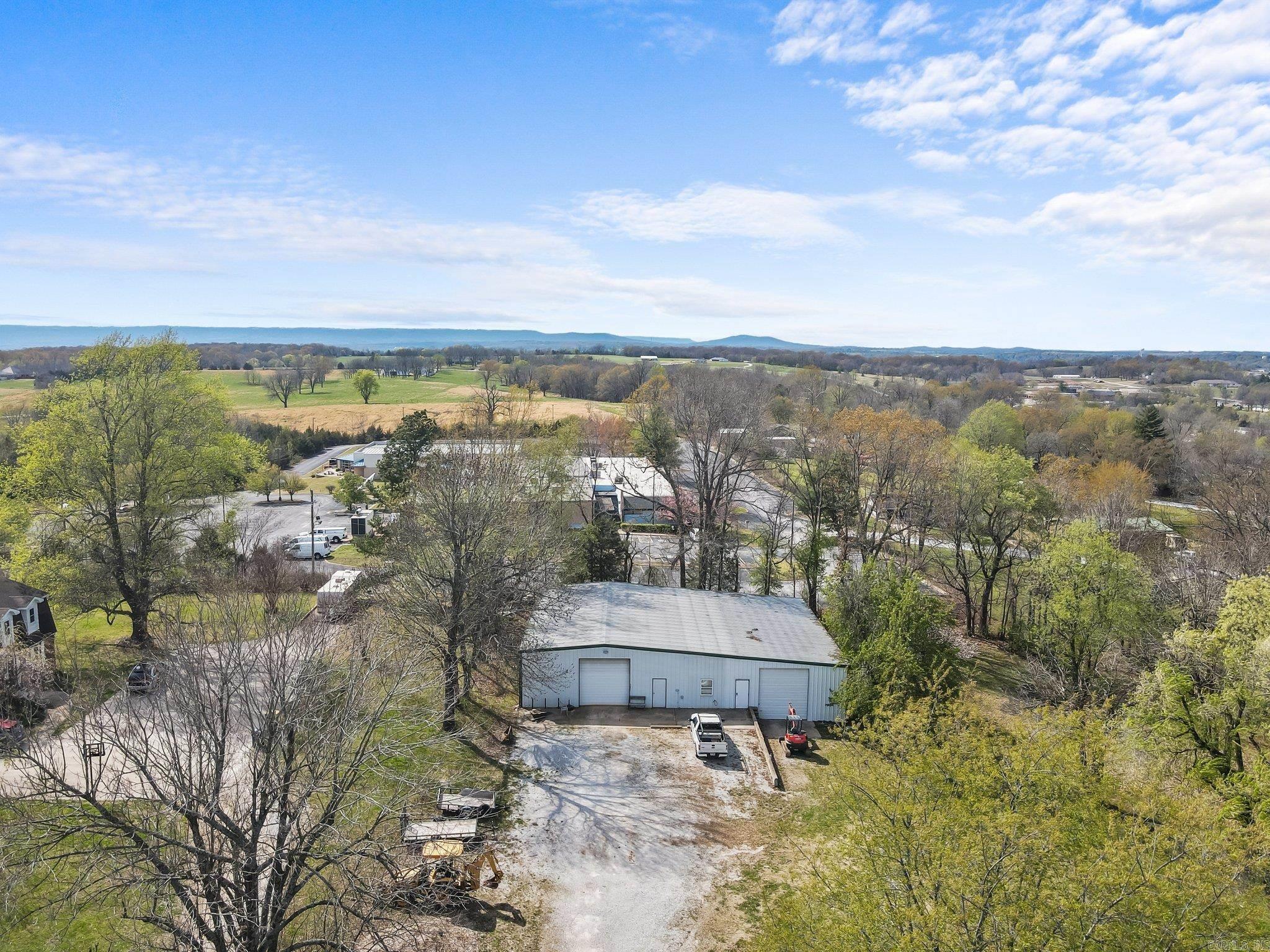 Take your business and home living to the next level. This Beautiful property sits on 5 acres with 460 sqft hwy 65 footage in the heart of Harrison. zoned C-3 commercial, it has 1.3 acres of cleared highway frontage, a 900 sqft office, 60-80 shop with separate drive and a beautiful newly remodeled home with above garage apartment. The main home has 4 bedrooms, and 2.5 baths. A large dining area with wet bar makes entertaining a breeze, a sunroom opens to a living area with fireplace and kitchen. granite countertops, double oven, built in microwave and white custom cabinets are sure to be a chef's dream. Primary suite has dual closets and access to your covered back porch, outdoor fireplace, and swim spa, walk in tiled shower, soaker tub, and dual sinks in custom granite vanity are sure to be the bathroom oasis you are looking for. 3 beds and 1 bath round out upstairs. Steps away from the home is the separate building which can be used as office space, or a rental unit. 870sqft and has a kitchen, bath and laundry. The 60-80 shop has two rolled entry's and has a bath and shower. This property has a ton of possibilities. Don't miss out! Call today.