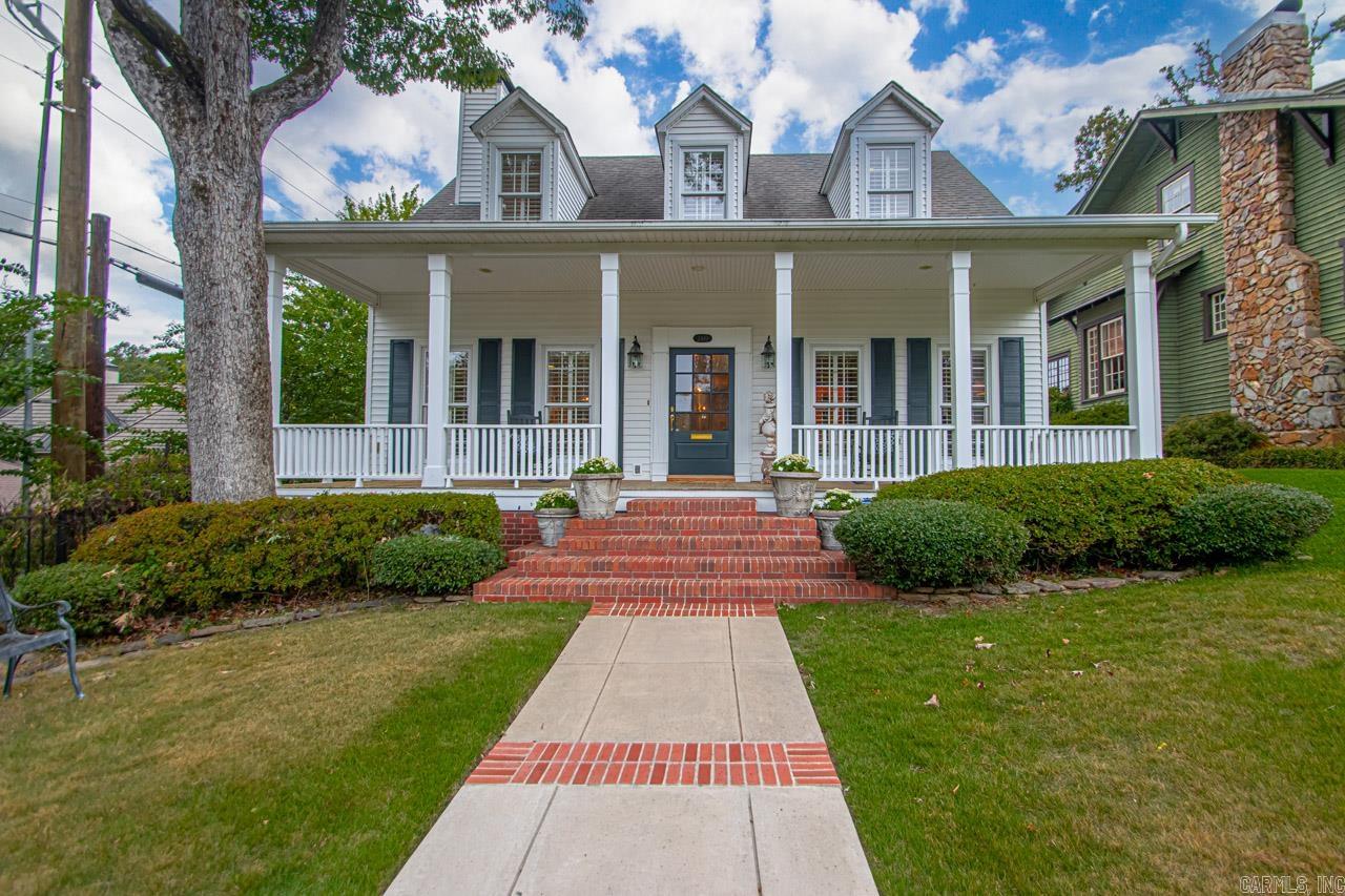 This charming, 3-bedroom, 2.5-bath traditional home offers classic elegance and modern comfort. The fantastic front porch opens to a large entry, formal living, and dining room that features built in shelves for storage and one of the two gas fireplaces. Throughout this wonderfully maintained house there is hardwood flooring and plantation shutters. The galley kitchen has unique quartzite countertops and top of the line appliances, including Wolf range. The kitchen opens to a separate cozy breakfast room and a large family room with a fireplace and coffered ceilings. The wool carpeted primary bedroom is adjacent to a gorgeous remodeled ensuite bathroom with marble flooring, flat entry shower, soaker tub and a custom walk-in closet. Upstairs features two bedrooms that share a spacious bathroom with a custom made mirror and ample storage including cute window nooks in each bedroom. Outside, a 2-car carport is accessible from the alley as well as outside storage. Enjoy the quiet back porch that overlooks a minimal maintenance garden. The proximity to the Country Club of Little Rock allows for easy access to golf, tennis, and other recreational activities. See Agent Remarks
