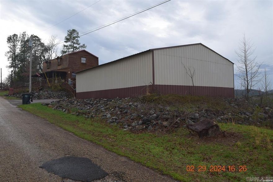 This home has a view to die for. All wood interior, floors are in excellent condition. Has at least a six car garage/Work shop. This home isall electric.