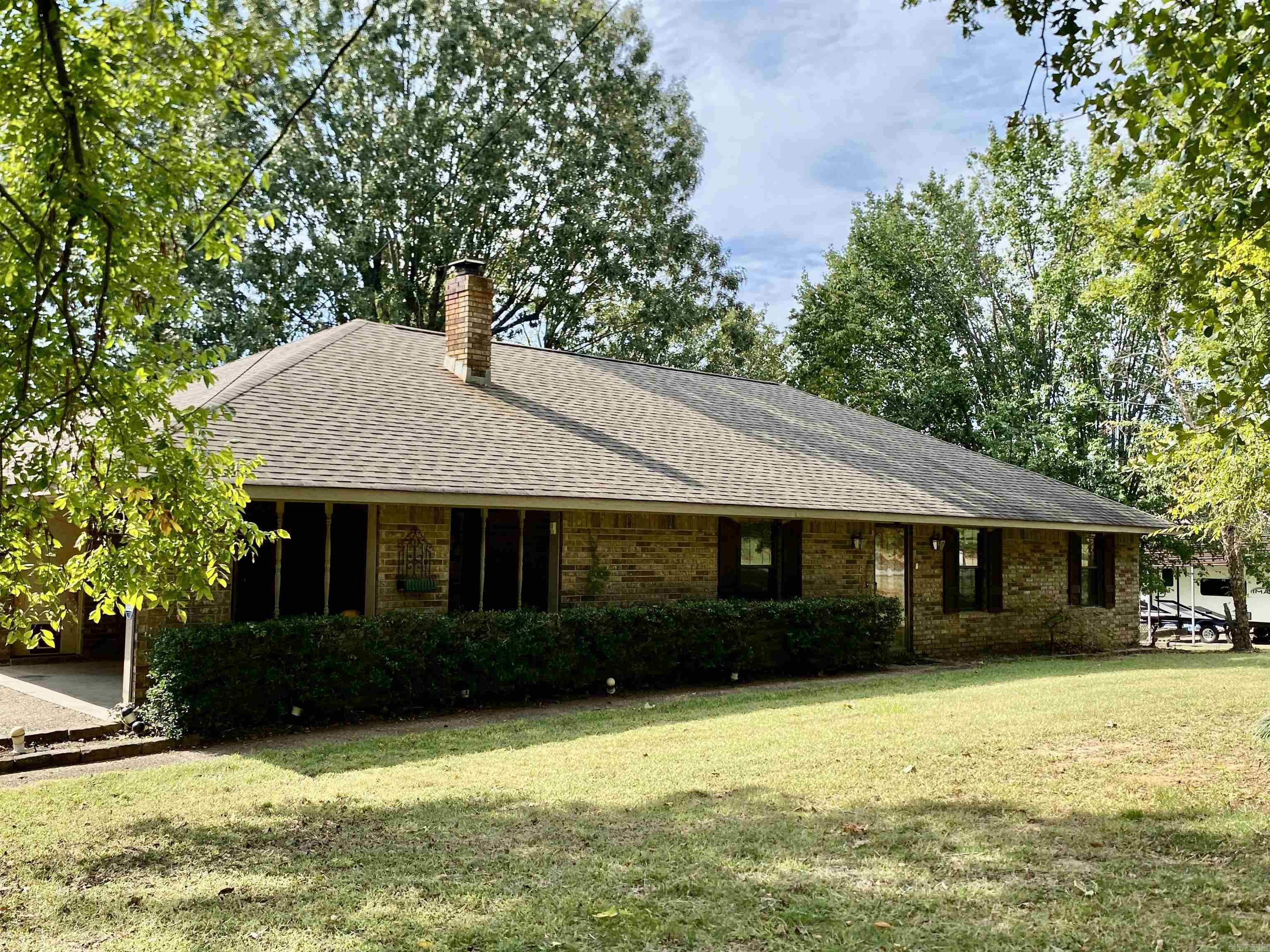 This charming home offers a perfect blend of comfort, character, and entertainment space. Step outside to the unique rock outdoor kitchen, complete with a fireplace, pizza oven, sink, refrigerator, and grill — truly an entertainer’s dream. A sun deck provides the ideal spot for relaxing or hosting friends, all just minutes from the Arkansas River. Inside, you’ll find a custom eat-in kitchen featuring stainless steel appliances, solid surface countertops, and a breakfast bar, along with a spacious laundry room and an inviting sun porch adding 204 sq. ft. of heated living space. The warm living area is centered around a wood stove framed by built-in bookcases, creating a cozy retreat. Set on a beautifully shaded lot, the property also includes bonus storage attached to the detached carport and an attached garage for convenience. Additional features include a roof approximately 10 years old and repaired settling with a lifetime transferable warranty — offering peace of mind for years to come. Priced accordingly as the home will need minor sheetrock repairs due to the settling.