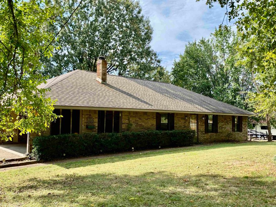 This charming home offers a perfect blend of comfort, character, and entertainment space. Step outside to the unique rock outdoor kitchen, complete with a fireplace, pizza oven, sink, refrigerator, and grill — truly an entertainer’s dream. A sun deck provides the ideal spot for relaxing or hosting friends, all just minutes from the Arkansas River. Inside, you’ll find a custom eat-in kitchen featuring stainless steel appliances, solid surface countertops, and a breakfast bar, along with a spacious laundry room and an inviting sun porch adding 204 sq. ft. of heated living space. The warm living area is centered around a wood stove framed by built-in bookcases, creating a cozy retreat. Set on a beautifully shaded lot, the property also includes bonus storage attached to the detached carport and an attached garage for convenience. Additional features include a roof approximately 10 years old and repaired settling with a lifetime transferable warranty — offering peace of mind for years to come.  Priced accordingly as the home will need minor sheetrock repairs due to the settling.