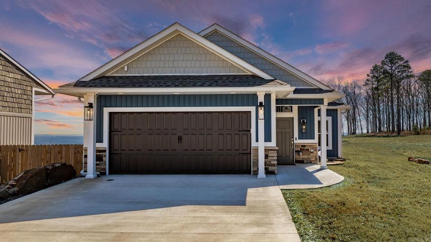 This beautifully designed 2023 custom home offers breathtaking views of Greers Ferry Lake and is perfectly situated in the lake resort town of Fairfield Bay. Just 10 minutes from the marina, minutes from the local grocery, & near 2 exceptional golf courses, this home provides both convenience and luxury. Featuring an open-concept layout, as well as aging in place in mind, with 3bedrooms and 2bathrooms, this home is thoughtfully built for comfort and ease. The completely flat design means no steps, and wheelchair accessible doorways, while the spacious walk-in tile showers add a touch of elegance. Storage is plentiful, and energy efficiency is top-tier with spray foam insulation and a Trane heat pump with humidity control.The upgraded KitchenAid appliances include double oven, ice maker, & trash compactor, making the kitchen as functional as it is stylish. A security system w/cameras ensures peace of mind. Also includes stacked, front load washer & dryer. For those who love extra space, the oversize toy garage comes with a mini-split for climate control, plus a floored attic over both garages for even more storage. The covered patio is the perfect place to unwind.