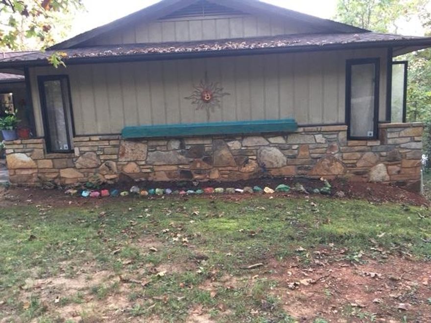 This 4 bedroom, 3 bath 2384 sf' home needs some 'cosmetic fixing'. It is nestled in a wooded setting in Cherokee Village. On the main level is an efficient kitchen/dining area, large open living area, the primary bedroom & bath, a guest room and another bath. Downstairs level has another large open living area with fireplace. There  2 additional bedrooms, combination laundry and bath, mechanical storage room and a workshop room. Upstairs level leads out to a large open deck and a covered cooking area. The back yard is fenced for your pets. There is a generous carport as well. This home is idea for family, vacation home or investment...with 2 -18 hole golf course and seven lakes in the area. Home needs a little love and care. Great square footage and great location!!!