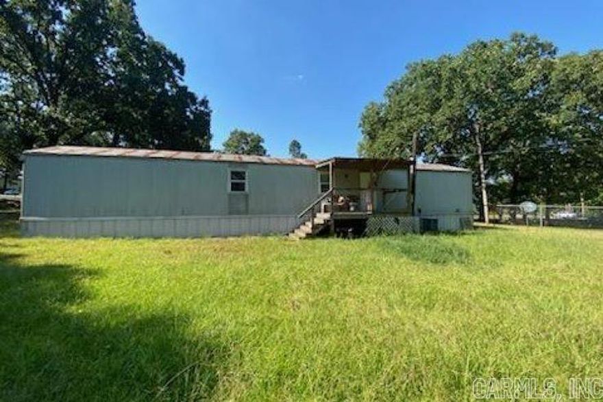 This beautiful piece of land is cleared and fenced as well as easily accessible with two gated driveways. The 20x20 shop was built in 2015 and has electricity, outside motion lights and a nightlight. You couldn’t want more in a safe room; check out the pictures!  As a bonus this roomy mobile home has a bathroom that is handicap accessible with handrails, featuring a walk in shower with seat and newer larger toilet than original. Also the hot water tank was replaced, only used for two years. The second bedroom has a large walk-in closet. It is also large enough for both a queen bed and full bed if more sleeping space is what you prefer. Not to mention new windows. Two covered porches provide the perfect spots to enjoy your property out of the elements.  The Oak Grove Community has amazing caring people! There are also multiple churches right up the road. This country setting is a few minutes from just about anything: restaurants, stores, parks, doctors, access to three interstates…