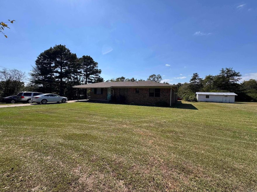 This 3 bedroom home is conveniently located just minutes from I-57 and Searcy Walmart, and includes a large 1.72 acre lot plus a shed building and larger storage building with lean-to area. The recent updates include paint, new roof in 2023, new hot water heater in 2025, new electrical breaker box in 2025. The hvac system had an added Ion Filter to reduce allergens. A storm cellar is located in the privacy fenced area of the backyard. Level lot with privacy but located on a paved road.