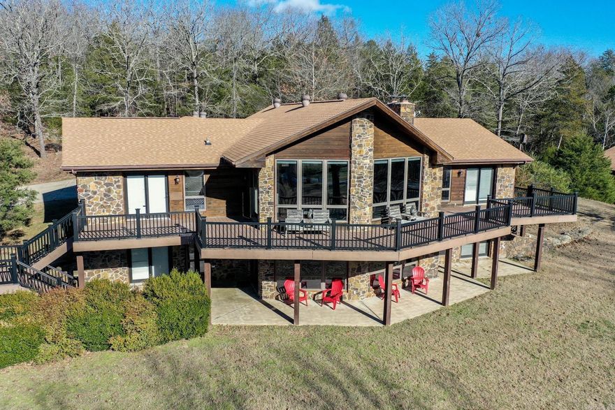 The Flippin Villa on The White River is the trophy trout fishing retreat you’ve been looking for, offering both exceptional recreation and strong income potential. Located 7.5 river miles downstream from the Bull Shoals Dam and just 4 miles below the famed Gaston’s Resort, this is a premier destination for anglers. The White River is second to none for trophy brown trout, along with an abundance of rainbow trout.  Set on approximately 8 scenic acres, this versatile estate offers space, privacy, and a serene setting ideal for personal enjoyment, hosting, or revenue generation. The property features a combined total of approximately 7,500 square feet across the main lodge and two guest cabins, offering a total of 10 bedrooms and 7.5 bathrooms—perfect for large groups or short-term rentals.  The main lodge spans over 4,700 square feet with four bedrooms, each with a private bath and outdoor deck. A gourmet kitchen, two stone fireplaces, and a blend of terracotta tile and hardwood flooring add warmth and character.  Cabin 1 and Cabin 2 enhance flexibility and income potential. With a proven high ROI income history, this fully furnished property is a turnkey investment opportunity.