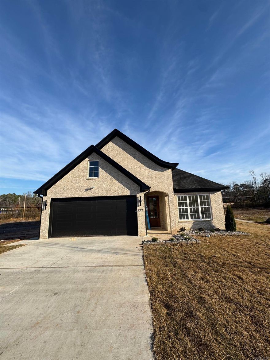 Welcome to Edgewood, the newest gem in luxury living in West Little Rock!  Nestled amidst lush landscaping and mature trees, Edgewood offers a tranquil retreat while remaining conveniently close to the best shopping and dining in the area. Enjoy the ultimate ease with our included lawn maintenance—say goodbye to mowing forever and spend your time relaxing in your beautiful new home!  This single-level residence, featuring 3 bedrooms and 2 full bathrooms, is designed to impress with its thoughtful layout. The primary suite is a private sanctuary, complete with a soaking tub, oversized walk-in shower, and a custom closet that fulfills every dream. Designer finishes and exceptional craftsmanship are evident throughout, elevating your living experience. Perfect for entertaining, the open-concept design includes a chef's kitchen with quartz countertops, custom cabinetry, and more. And don’t miss the charming outdoor fireplace, ideal for cozy Fall evenings on your back porch.