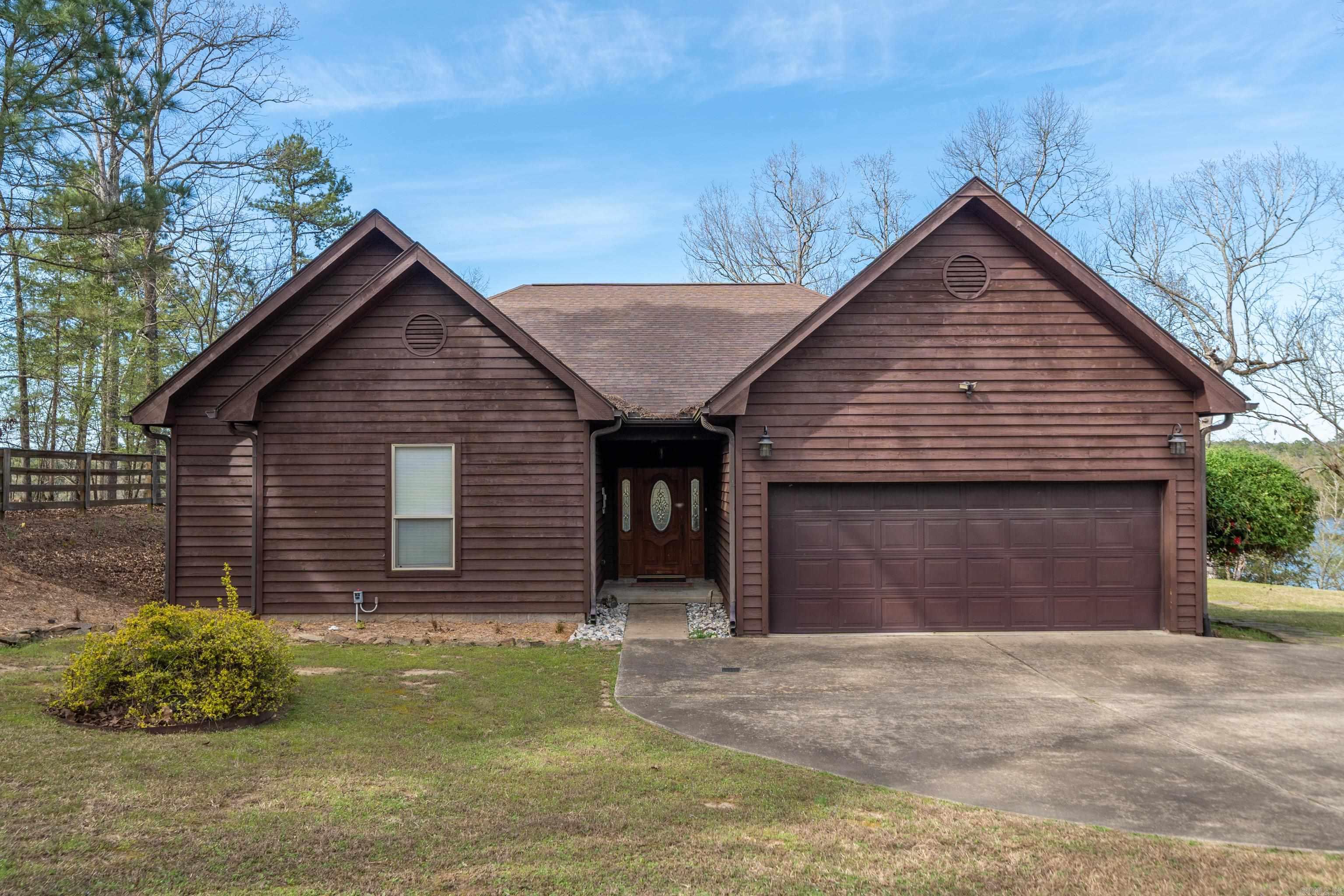 Step into this beautiful lakeside retreat featuring 3 bedrooms, 2 bathrooms, and 2,113± sq ft of living space. Set in a private country location, this home offers stunning views of the lake and mountains. Enjoy the outdoors from the spacious deck, or take advantage of the double-stall, covered boat dock with a lift and swim dock, providing year-round water access. Inside, the home blends rustic charm with modern features, creating a welcoming and comfortable atmosphere. Schedule your showing today to see this fantastic property!