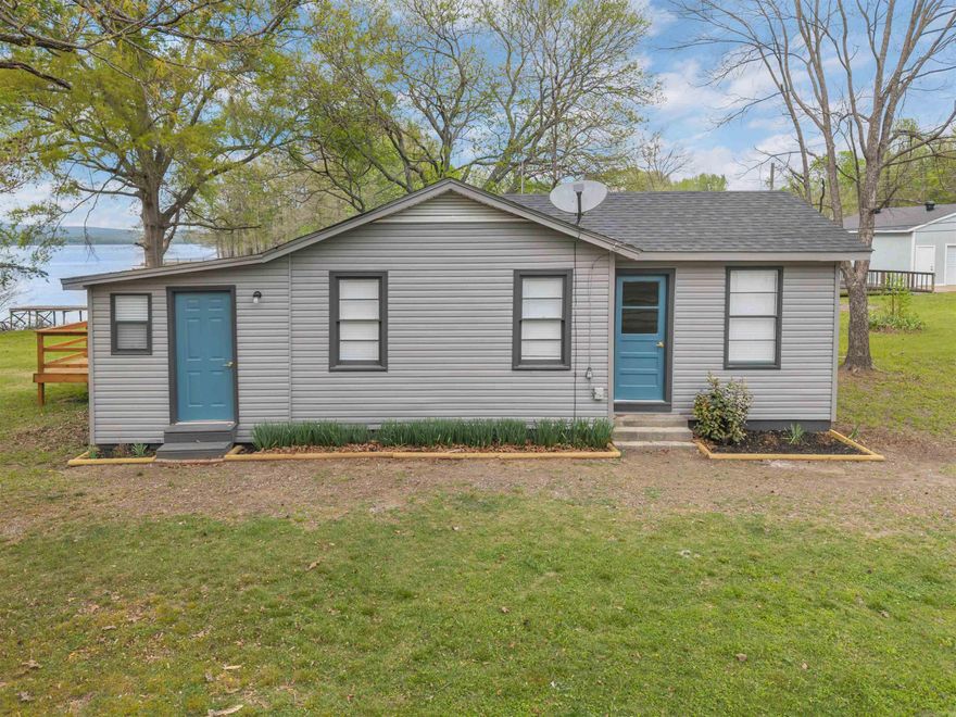 Completely remodeled lakefront home on Harris Brake Lake! This move-in ready property features a beautifully updated dock and a spacious new back porch—perfect for relaxing or entertaining while taking in the water views.  Inside, the home has been thoughtfully renovated from top to bottom, including the crawlspace, plumbing, roof, paint, flooring, cabinetry, and appliances. The layout offers 3 bedrooms with generous closet space, a dedicated laundry area, and a stunning kitchen with all-new appliances.  The living room is filled with natural light from large picture windows that showcase peaceful lake views. Enjoy the convenience of city water and fiber internet, all while experiencing the best of lakefront living. Ideally located with easy access to Russellville, Conway, and Little Rock!