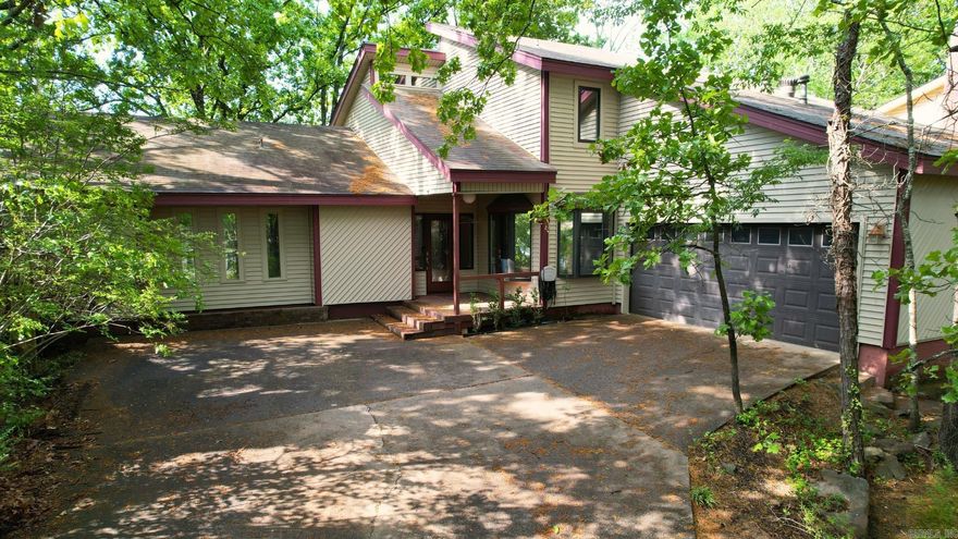 Step into an architectural time capsule in the heart of West Little Rock. This home, built in 1979, showcases distinctive 80’s contemporary design with character you won’t find today.   The two-story living room is the centerpiece of the home, anchored by a rock fireplace and framed by a roofline that defines its unique style. A skylight brings in beautiful natural light, enhancing the open, airy feel of the space.  Downstairs, the secondary bedrooms feature soaring half-pitched ceilings that add volume and personality. Upstairs, the primary suite offers a private retreat with a perfectly preserved, original tiled shower surround—an authentic nod to the era. The primary bedroom doubles as a mezzanine overlooking the living room below, creating a flexible space ideal for entertaining, lounging, or a creative studio. The ensuite is completed with a walk-in closet and sitting area with bay window.   Outside, the low-maintenance yard embraces a natural design with mature trees and a mossy ground cover-perfect for those who prefer less mowing and more enjoying. In the backyard, a concrete patio provides a great spot for gatherings, and is enclosed with a newer fence for added privacy.