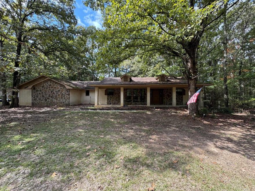 Location Location Location! Lots of potential with this stone/brick ranch on 2.46 acres!  Separate detached 24 x 36 garage/shop. Beautiful large trees surround the home. Den/Bonus room in the garage attached to the home.  Stone wood-burning FP insert in a nice sized living room.  Barn and other outbuildings.
