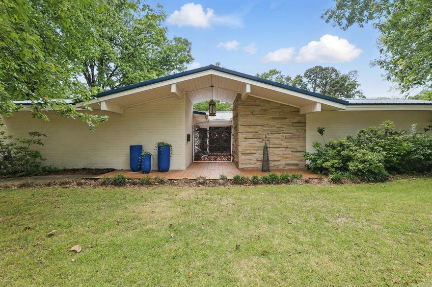 Welcome to this stunning 3-bedroom, 2.5-bathroom home nestled in the desirable Briarwood subdivision. From the moment you arrive, you'll be welcomed by swinging iron gates that hint at the unique character found throughout this mid-century modern gem. Inside, the home offers a rare and versatile layout, featuring a formal living room adorned with classic Tudor-style lighting, a cozy sitting room just off the kitchen, and a spacious den-providing multiple spaces for relaxing or entertaining. One of the standout features is the back of the home, lined entirely with windows, flooding the space with natural light and offering a seamless connection to the outdoors. The oversized garage provides plenty of storage, and the .68-acre lot delivers room to roam. Step out back to your private retreat with a deep in-ground pool, perfect for summer gatherings or peaceful evenings under the stars. Located in the heart of Little Rock, this home blends timeless design, unique features, and an unbeatable location-making it truly one of a kind. Metal roof installed in 2018.