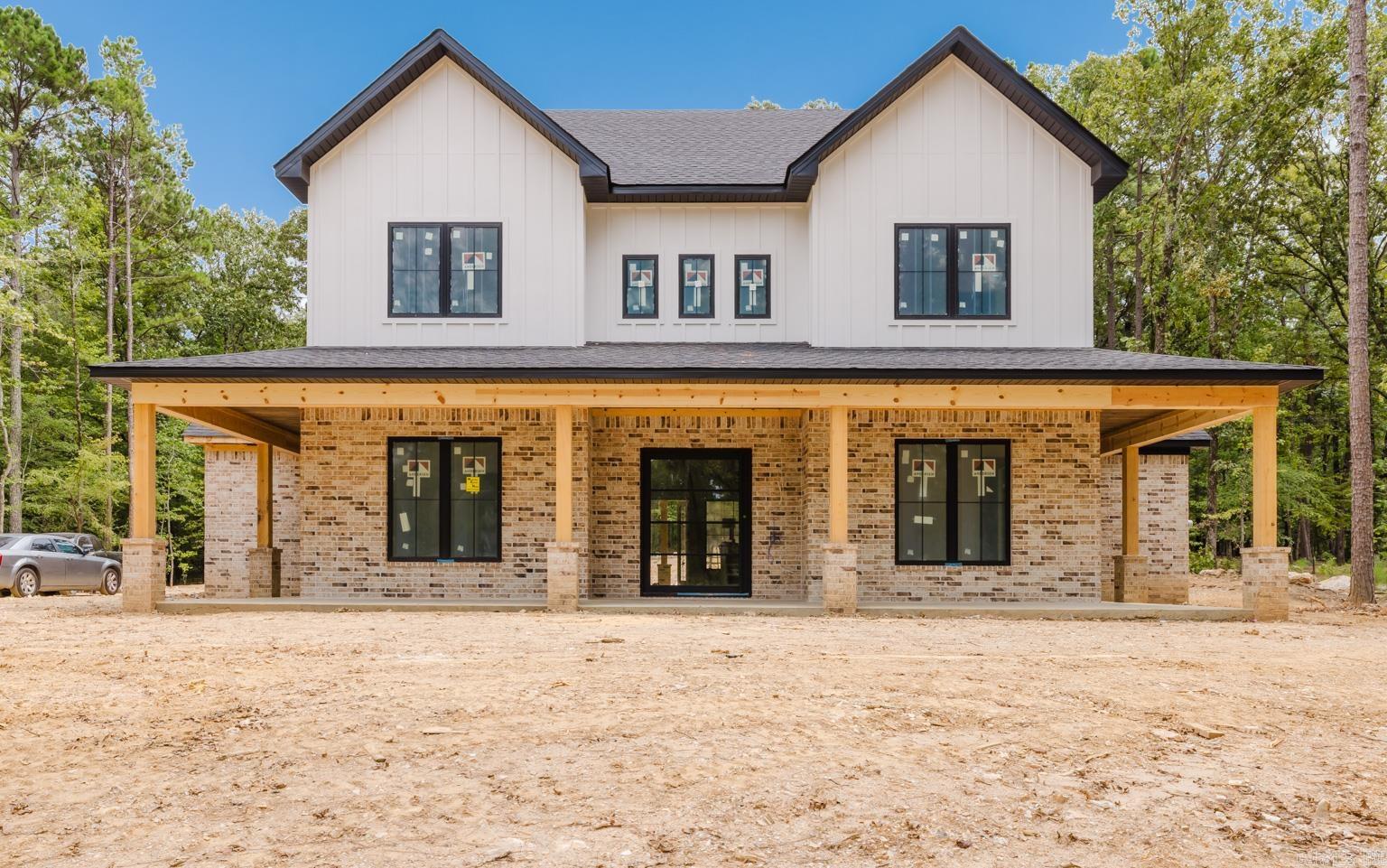 Dream home alert! Situated on a wooded, acre-sized lot, this home offers numerous amenities and understated luxury. You are welcomed into a large foyer by a gorgeous iron and glass pivot door. The living room steals the show though, with soaring ceilings, floating shelves, and windows looking out over a large covered patio with an outdoor fireplace for cooler nights. The kitchen is a culinary haven with numerous white oak cabinets, a large island, and double ovens. The home chef will love the butler pantry AND spacious walk-in pantry. A nearby dining room has numerous windows for natural lighting and built-ins for storing seasonal dishware. The primary suite is fantastic, and features tiled walls with a large shower and freestanding tub in the bathroom as well as his/her vanities and large walk-in closet. An office, half bathroom, mudroom, and large laundry room round out the main level. Upstairs, there are 3 additional bedrooms, as well as two more bathrooms. Also upstairs is a large bonus room. Once completed, home will have accent walls, wiring for surround sound, extra storage garage for an ATV/tool room and/or potential exercise room, an irrigation system, and so much more.