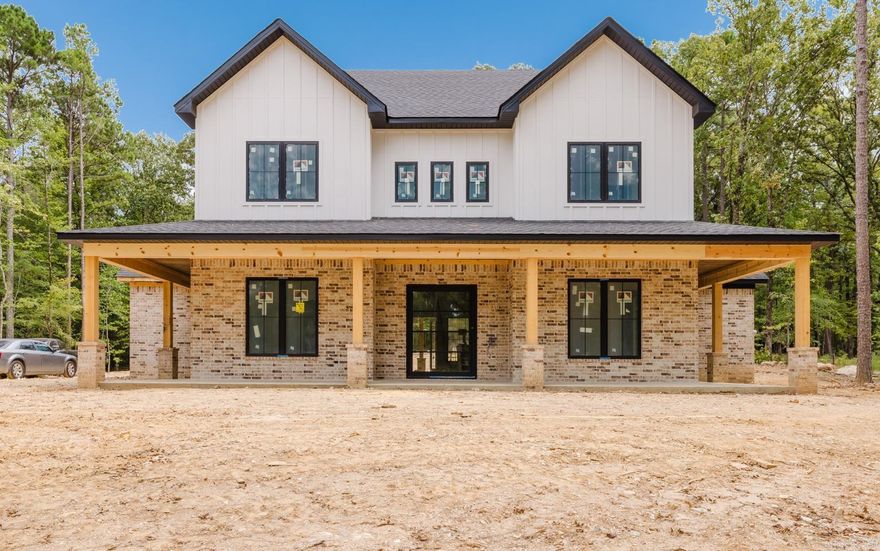 Dream home alert! Situated on a wooded, acre-sized lot, this home offers numerous amenities and understated luxury. You are welcomed into a large foyer by a gorgeous iron and glass pivot door. The living room steals the show though, with soaring ceilings, floating shelves, and windows looking out over a large covered patio with an outdoor fireplace for cooler nights. The kitchen is a culinary haven with numerous white oak cabinets, a large island, and double ovens. The home chef will love the butler pantry AND spacious walk-in pantry. A nearby dining room has numerous windows for natural lighting and built-ins for storing seasonal dishware. The primary suite is fantastic, and features tiled walls with a large shower and freestanding tub in the bathroom as well as his/her vanities and large walk-in closet. An office, half bathroom, mudroom, and large laundry room round out the main level. Upstairs, there are 3 additional bedrooms, as well as two more bathrooms. Also upstairs is a large bonus room. Once completed, home will have accent walls, wiring for surround sound, extra storage garage for an ATV/tool room and/or potential exercise room, an irrigation system, and so much more.