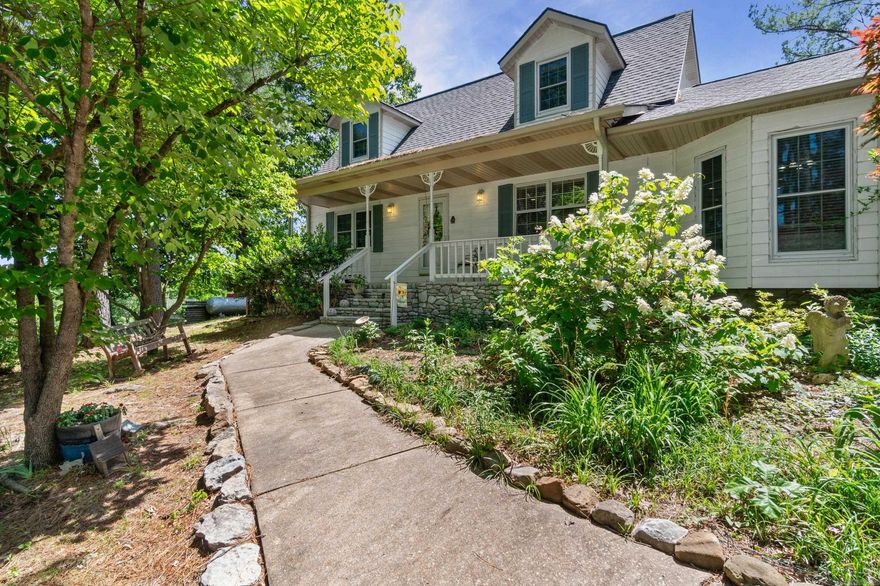 Beautifully designed home and garden estate on 2.2 lush acres in scenic Mountain View offering approx. 2,700 SF, 3 bedrooms, 3 full baths, and an attached 2-car garage. Ideally located just minutes from the Ozark Folk Center, downtown Mountain View, local music, dining, and only about 13 minutes from Round Bottom access on the White River—offering quick access to fishing, floating, and the best of Ozark recreation. Inside, the lower-level features updated flooring, a chef-style kitchen, breakfast room, spacious laundry/mud room nook with wash sink, updated bath with shower, private back entry, and a primary suite with large walk-in shower, jetted tub, and walk-in closet. Upstairs offers Tiffany-style lighting, additional bedrooms/bonus space, and a gorgeous glass-enclosed sunroom with private stairway leading to the back patio and gardens. Outdoors, enjoy wraparound decking, flowering gardens, muscadine vines, rolling hill views, and mature pines and hardwoods. Additional highlights include a heated and cooled art studio/office, covered RV parking with power and water, and a 24x30 barn with loft over a unique safe/storm room. An art lover’s paradise blending nature with luxury.