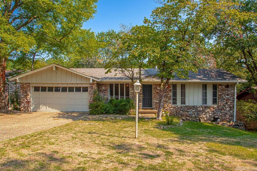 Want the privacy of the woods with all the convenience of the city? This home is the best of both worlds! Located on a quiet, low traffic street near a cul-de-sac, this home has a beautiful wooded lot that backs up to the River Mountain Trail system with easy access to Two Rivers Park for miles of hiking and biking! The main level offers 3bds, 1.5ba and a bright living area, while the walk-out lower level features a second living space with cozy fireplace, private bedroom and full bath for a total of 4bd 2.5ba. Large eat-in kitchen connects to the spacious 400 sq ft deck with amazing views of the woods. Updated paint, floors, and bathrooms makes it move in ready! There is a workshop off the garage as well as a walk in basement workspace. Relax by the fireplace in the downstairs den or off the back patio surrounded by nature! Zoned Don Roberts, Pinnacle View, & Central per LRSD.org Less than a mile from I-430, shopping, and dining.