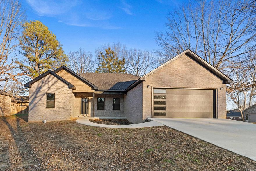 Beautiful new construction all-brick home located in the heart of Mountain Home, offering quality craftsmanship and modern design. This 3-bedroom, 2-bath residence features a desirable split-bedroom floor plan providing privacy and functionality. The open-concept living area is ideal for both everyday living and entertaining, highlighted by quartz countertops, modern finishes, and seamless flow between the kitchen, dining, and living spaces. The primary suite is a true retreat with a spacious walk-in closet and a spa-inspired bathroom featuring a freestanding soaking tub and a separate step-in shower. Two additional bedrooms are well-sized and share a full bath. Enjoy the efficiency of natural gas, including a tankless water heater for endless hot water. The attached two-car garage adds convenience and storage. All brick exterior offers timeless curb appeal and low maintenance. Located close to shopping, dining, schools, and medical facilities, this home combines comfort, efficiency, and location. A must-see opportunity to own a brand-new home in one of Mountain Home’s most convenient areas.