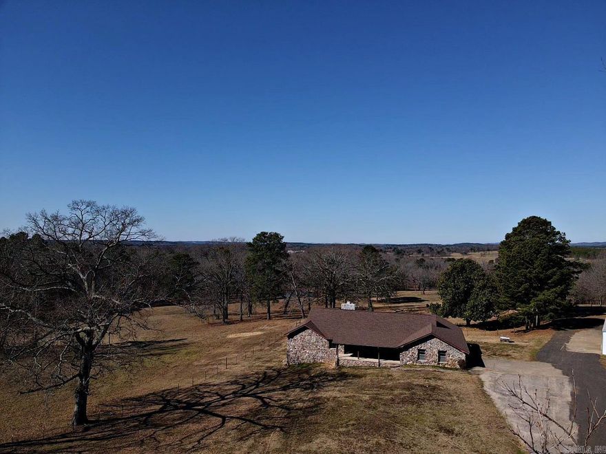 Located in the heart of Bismarck and on the main thoroughfare of Highway 7, this beautiful 4-bedroom, 3-bathroom split level home sits on 4 acres. The roof was replaced in 2024 along with many updates. Master suite and large bathroom plus an additional large bedroom and bathroom with a private entrance is also located on the main floor.  The beautiful rock fireplace currently has a gas heater installed but could be converted back to wood or gas logs installed. The walk-out basement is great for entertaining and watching the livestock nearby.  It contains another living and sleeping areas plus fireplace.  All furnishings convey with property.  Come enjoy the country setting as a permanent residence or an investment property.  See agent remarks.