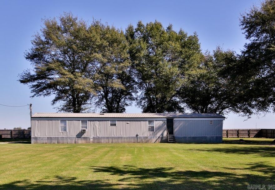 Welcome to 3934 N County Road 17 in Leachville, AR! This is a well-maintained 3-bedroom, 2-bath manufactured home situated on a 1+/- acre fenced lot surrounded by beautiful shade trees. The property features a metal roof installed in 2020, an electric water heater replaced in 2021, and a functional split floor plan.   Enjoy plenty of outdoor space with a fully fenced yard, landscaped trees, and a cleared, level lot. A large shop with two garage doors provides great storage or workspace, and a storm shelter adds extra peace of mind. The home includes laminate flooring throughout, city water, and a 1200 gallon septic system. Call today to schedule your tour!!