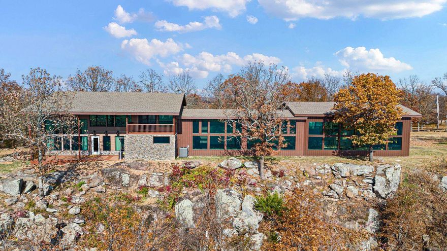 Rustic meets modern. This home sits on the bluff of Crow Mountain, offering unobstructed panoramic river valley views. A beautiful wooded lot with mature trees surrounds the property, which has been fully remodeled with sleek, contemporary finishes and new mechanicals. With 3.9 acres, an oversized four-car attached garage, and a 30x40 shop, this property is perfect for a small business owner or those seeking woodworking or flex space. Commercial-grade double-pane UV energy-efficient windows provide protection from heat and cold with low energy bills. The ultimate blend of luxury, privacy, and functionality! The master suite features a huge shower room with double showers, a toilet-urinal room, and a walk-in closet. A second bath includes a jet tub and shower. This smart home boasts new MyQ garage door openers and doors, a brand-new high-efficiency HVAC heat pump system with a smart thermostat, a Samsung fridge with Family Hub, smart GE washer and dryer, a Ring doorbell, and a six-camera security system.