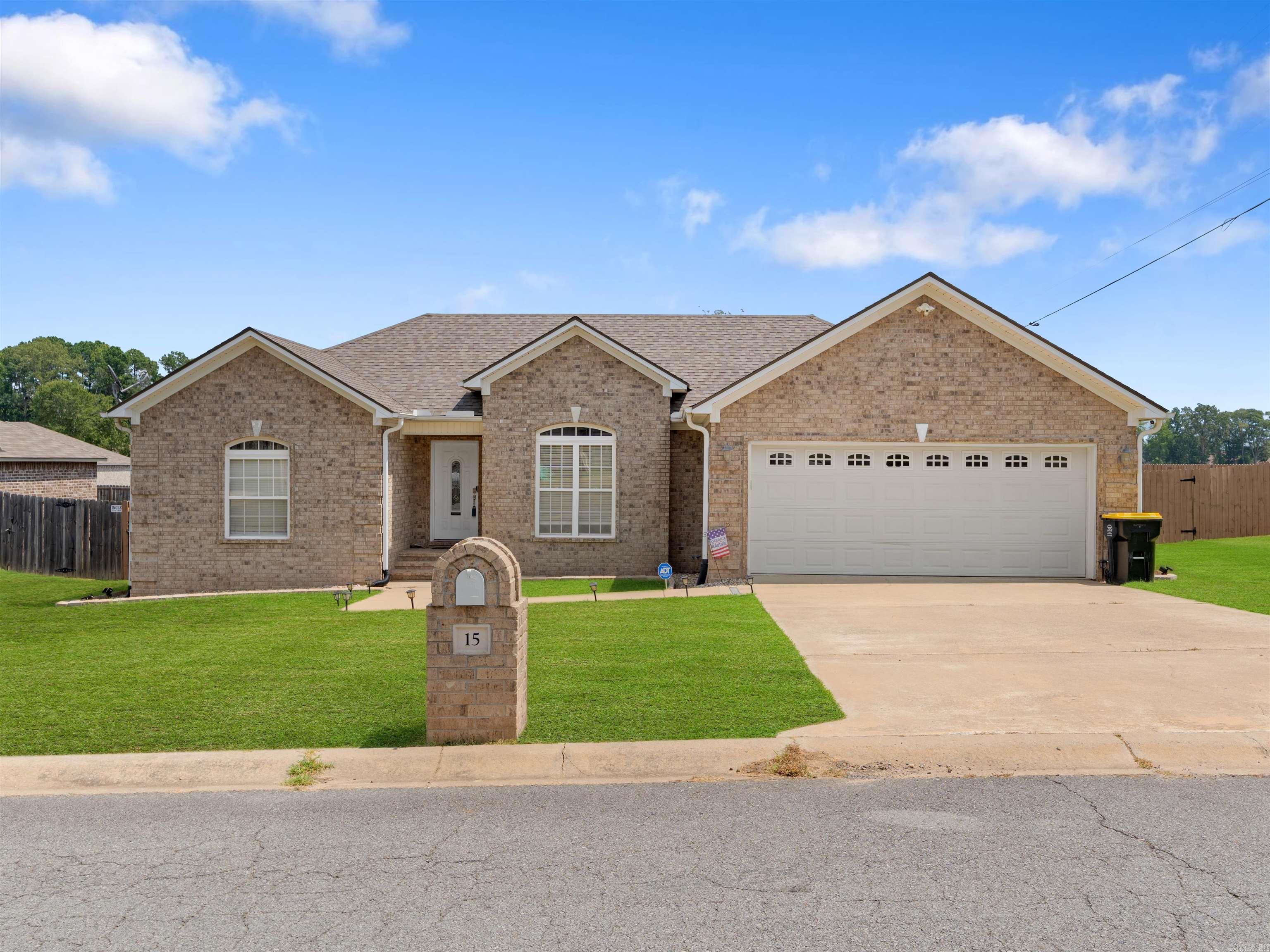 Better than new! This beautiful 3-bedroom, 2-bath home with a 2-car garage sits on a spacious corner lot and truly checks all the boxes. Step inside to find granite countertops, luxury vinyl flooring, a mix of tile and carpet, and a well-designed split floor plan. The great room offers a warm, inviting fireplace and stunning windows that overlook the large backyard. The kitchen and dining area open onto a peaceful screened-in porch—perfect for morning coffee or evening relaxation. The primary suite is a true retreat with a huge walk-in closet, dual vanities, a soaking tub, and a separate walk-in shower. Two guest bedrooms share a hall bath. Bonus features include a whole-house generator, french drains tied into the gutter system, built-in security system, and the entire home is wired for high-speed internet—ideal for remote work, streaming, and smart home upgrades. This home blends comfort, security, and modern convenience—move-in ready and made for living!