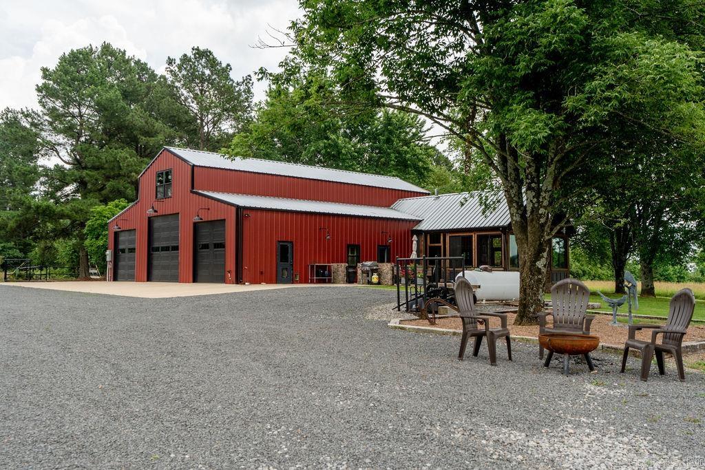 This unique property offers 71 beautiful acres with 30 acres of pasture, 40acres of rolling woods with wide trails, a refurbished pond. new well for irrigation and custom fenced garden area. The well built 48'x60' shop has 6" thick concrete floors, steel beam construction, foam insulation and fabulous living quarters, all combined in one great package. The 2 bdrm / 2 bath shop home is high end with tall wood ceilings, ship lap walls, gas fireplace, plantation shutters and stained concrete floors. The star of the show is the heated/cooled porch with vaulted ceiling, cedar posts and beams, wood burning fireplace and windows that open for a screened porch experience or close to enjoy the AC or Heat provided by a Mini-Split. Additional features: 'world's greatest deer stand', whole house Generac generator (22kw), Anderson windows and sliding doors, an upstairs office (21' x 18') and Mineral Rights to convey with full price offer.