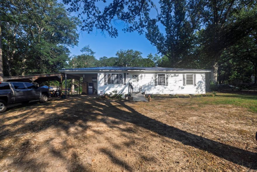 Nestled on nearly one and a half acres of picturesque land, this charming three-bedroom, one-bath home offers a perfect blend of comfort and space. The property features a brand-new three-car carport, providing ample parking and storage options. Inside, you'll find a spacious living area that invites relaxation and gatherings, making it ideal for both family life and entertaining guests. The layout is thoughtfully designed to maximize the use of space while maintaining a cozy atmosphere. Surrounded by nature, this home is a serene retreat, offering the perfect backdrop for outdoor activities and peaceful living. Don't miss the opportunity to make this delightful property your own.
