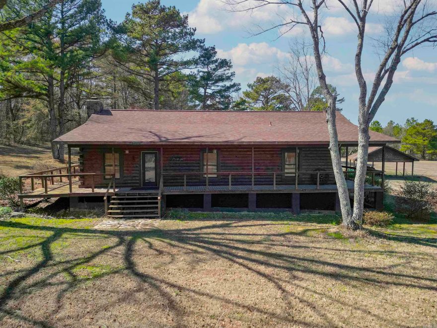 Cozy 3 bedroom 2 bath log home with wrap around porch, large living area with stone fireplace, stainless steel appliances, wood floors in living area, ceramic tile in  wet areas, primary bedroom has a large walk-in closet, walk-in shower, barn with tack room, sitting on 7 acres!