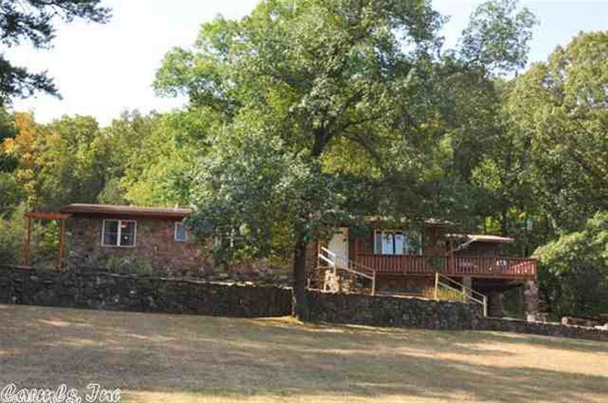 Great home on 4.6 acres has been updated throughout. Walls removed, new flooring and new paint throughout.  New plumbing and electrical work too! Master bath has a BIG Deep soak whirlpool tub. New energy efficient windows.  Screened in porch and deck off the side with great views. Woodburning fireplace, and an outside storage building. Private location at end of street.  You won't believe how great the utility bills are!!!!!