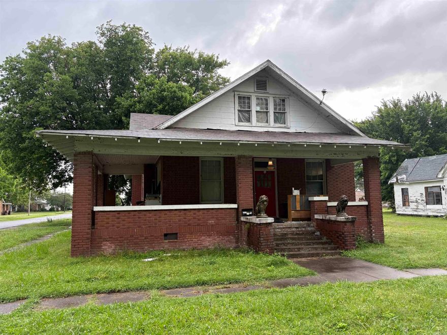 Nestled off NE 4th St and St. John, this spacious five-bedroom, two-bath home offers classic charm with a brick exterior and a welcoming covered front porch. Inside, you'll find hardwood floors throughout most of the home, a generous kitchen with ample cabinet space, and plenty of room for a growing family or hosting guests.  Out back, a large, solidly built garage/workshop provides versatile space for storage, hobbies, or outdoor gear. Situated in the heart of a thriving farming community and renowned duck hunting region, this property is ideal for those who love the outdoors.  Being sold as is, this home is a perfect canvas for updates and personal touches. With the right improvements, it could serve as a comfortable full-time residence or a fantastic home base for hunters and their families.
