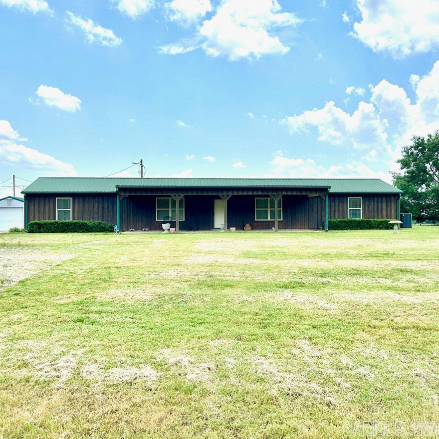This beautiful 1600sq, 2 BR/ 2 BA home sits on approximately 1.40 acres with a concrete driveway leading to 24x32 insulated shop with electricity.  Spacious Living with open concept to the Kitchen area that offers: Beautiful Hardwood Cabinets. Island Bar, with pleanty of counter space. Primary Bedroom with Handicapped Tile Shower, Walk-In-Closet that includes laundry.   Home is Handicap accessible, Covered Front Porch, and Carport.  Lots of windows for viewing the landscaped yard.