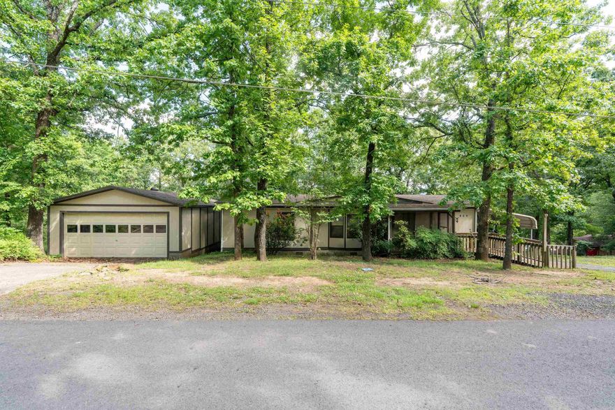 It’s fishing & boating season! Check out this well-maintained 3BD/2BA, 1,248 SF doublewide manufactured home on a permanent foundation with seasonal Greers Ferry Lake views on two lots, just a short walk from Choctaw Landing’s unique primitive boat ramp. Nestled among mature trees with abundant wildlife and natural beauty, this property is ideal for lake living, fishing, boating, RV storage, and relaxing weekends by the firepit after a long day on the water. The inviting floor plan features a spacious living room, large primary bedroom, breakfast nook, and easy access to the screened-in porch for enjoying peaceful mornings and cool evenings in the trees. Additional features include a 640 SF detached 2-car garage, 12x23 carport, 220 SF screened-in porch, oversized insulated heated & cooled 40x30 utility/boat shop with tall sliding doors, large RV/5th wheel cover with 220 power, and an additional storage outbuilding. Extra lot access from Choctaw Landing Rd provides outstanding flexibility for boats, campers, side-by-sides, and other lake toys. Conveniently located near Choctaw Recreation Beach, near Johnson Hole record fishing area, and only 10 mins from Clinton Walmart/Hospital