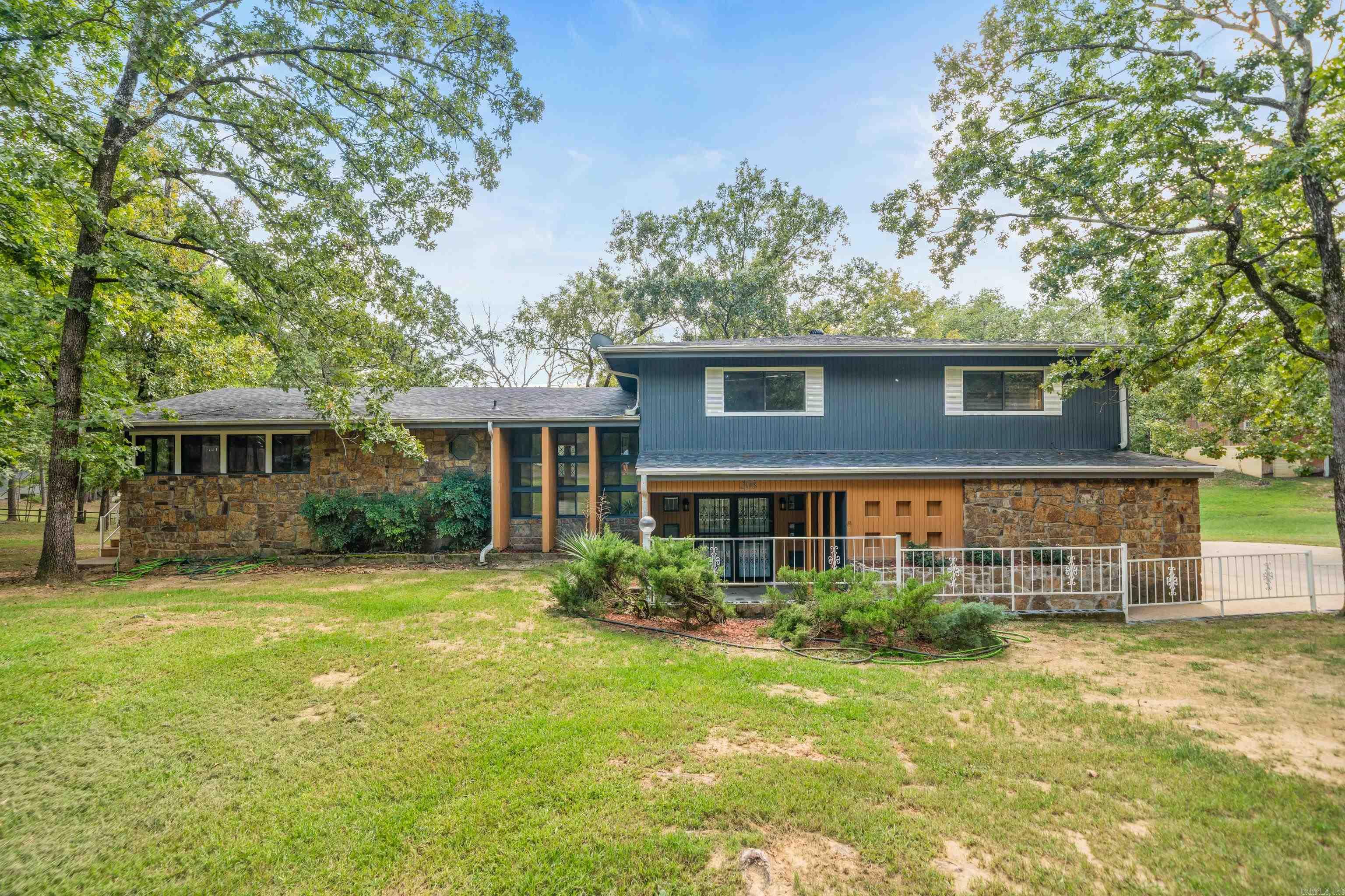 This beautifully maintained 3-bedroom, 3.5-bath, 2,926 sqft lakefront home was solidly built by a contractor for his personal residence—quality and thoughtful craftsmanship is evident throughout. Set on just under 2 wooded, peaceful acres overlooking the lake, this home offers the perfect blend of comfort, privacy, and outdoor living. Recent updates include granite countertops, refinished cabinets, updated flooring, fresh interior and exterior paint, new hardware and fixtures, and upgraded electrical and plumbing systems. Enjoy two spacious living areas (or game/movie room), a giant two-level deck for entertaining, and a freshly painted boathouse, grandfathered in, with a new boardwalk. The home and boathouse both have 50 year roofs, under 2 years old. Bonus: An additional 800 sq ft of basement space (not included in the listed square footage) provides ample room for storage, a workshop, or future expansion. You don't find land like this on the lake very often! The large level lot is perfect for privacy or has the potential for additional builds. This move-in ready home is the perfect combination of craftsmanship, modern updates, and a serene setting with beautiful lake views.