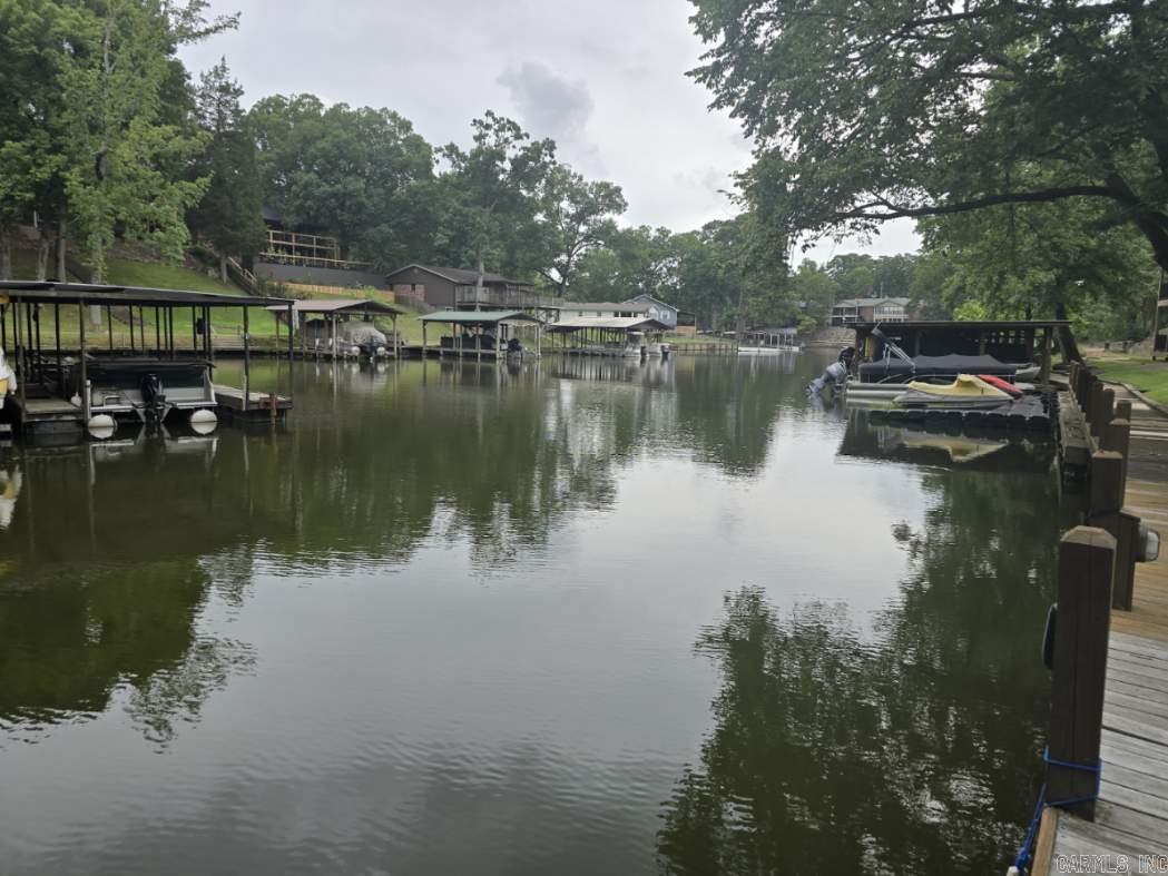 Stunning 2-bed, 2-bath condo in a peaceful cove, perfect for relaxation and water activities! Enjoy granite countertops in the kitchen and bathrooms. Private boat ramp and boardwalk for easy access to boating adventures. Go fishing or simply soak in the serenity of the water. Exclusive access to a community pool and poolside cabana for ultimate relaxation. Agents see remarks