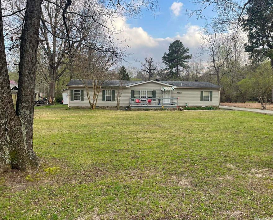 This 1995 model 3 bed 2 bath manufactured home has 1664 sq ft of living space. This home is open concept with central heat and air and a gas fireplace.  New roof put on in 2020.  Home has an attached carport and sits on .45 acre lot.  Small storage building for lawn tools and outdoor storage.  This home is in a great location and priced to sell!