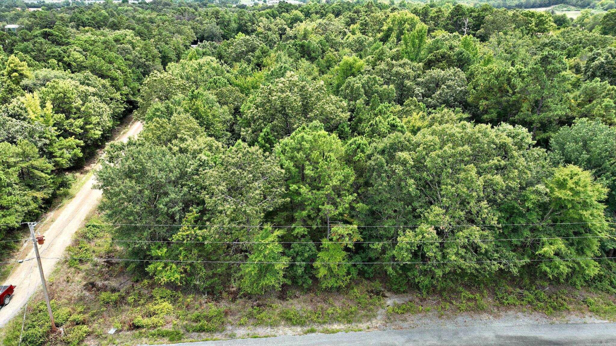 Discover the perfect blend of country living with convenient proximity to town. This corner property boasts mature trees and offering ideal building sites, making it a great spot to create your dream home. There are 2 lots totally 2.04 acres, sold together with potential for a contractor to separate for 2 homes. Enjoy the peace and tranquility of a natural setting while still being close to all the amenities you need. Protective covenants are in place to maintain the cohesive appearance in the homes built across the neighborhood. Please note, mobile homes are not permitted. Small/seasonal creek on back side.