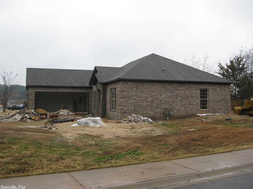 Excellent New Home with a Formal Dining Area, Granite Countertops, Custom Cabinets and wood, tile and carpeted floors. Side entry garage, back porch, rock accent on exterior and a circle drive.