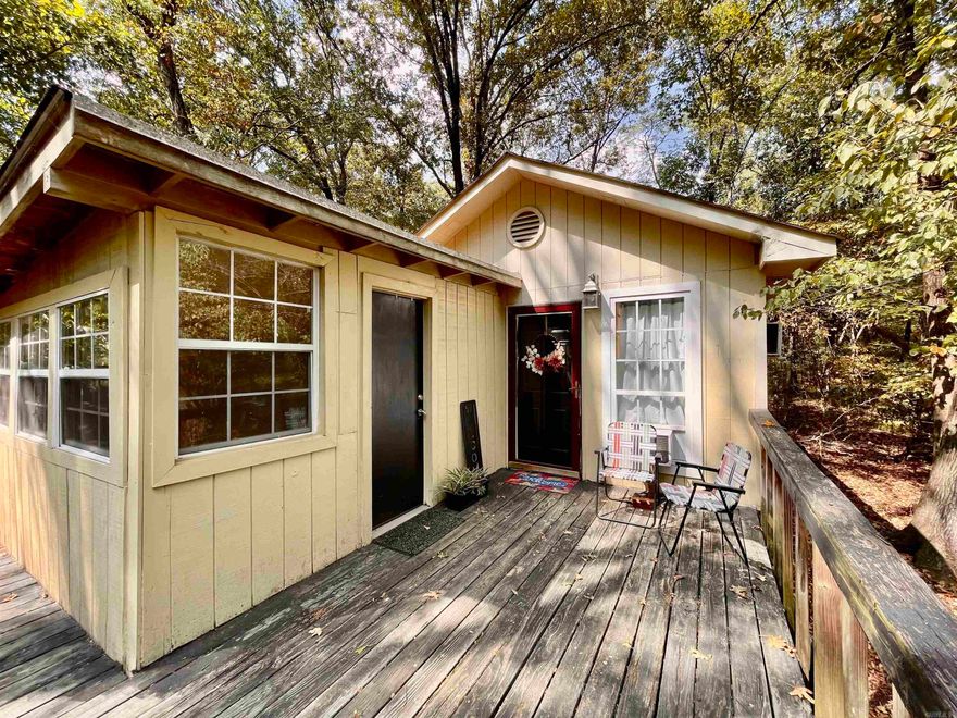 Longing for a little place of your very own? This adorable artist's bungalow secluded on 1.32 acres may be just the spot for you! There is more than meets the eye to this studio home with all of the amenities you are used to. All appliances are included with the sale. This cozy home also has a little workshop to the left of the front door! Come take a look at this fantastic property and imagine all the ways you can make it your own!  The property is being sold "AS IS." Agents, see remarks for showing instructions.