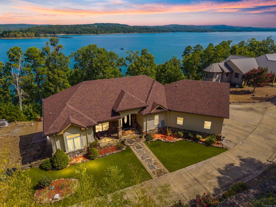 Welcome to your dream retreat on beautiful Greers Ferry Lake! This luxurious lakefront home is full of warmth, character, & high-end finishes—from stunning in-laid floors to customized cherry wood trim, cabinets and beautiful doors. The open floor plan offers bright, spacious living with breathtaking lake views from nearly every room—perfect for relaxing or entertaining. A grand, sweeping staircase connects two inviting living areas, each with its own cozy fireplace. Enjoy movie nights in the dedicated theater area & host friends & family with ease in multiple entertainment spaces. The walk-out basement opens to a large patio—ideal for lakeside gatherings and sunset views. A gourmet kitchen with generous pantry makes entertaining effortless, while the built-in tornado and storage room adds extra peace of mind.   For added convenience, nearby boat launch & storage facilities make enjoying the lake even easier—bring your boat, jet skis, & water toys with confidence. Located twenty minutes from Sugar Loaf park & twenty minutes from Highway 65.    2x6 Construction, spray foam insulation, New Roof in 2025, newer DW&Fridge, oversized 2 car garage (700+sqft) Lake living at its finest!