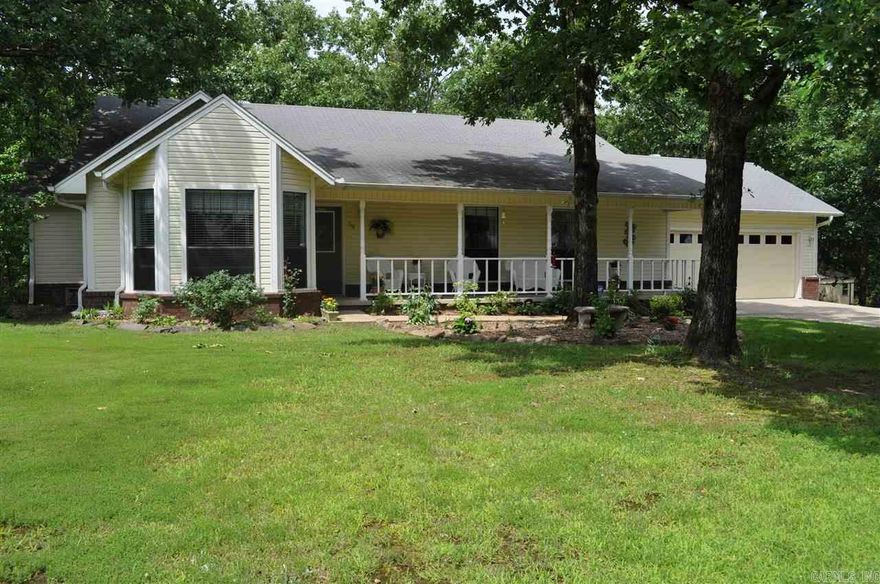 Spacious home in established neighborhood offers 3 bedrooms, 2 baths, huge living room w/wood burning fireplace & wood laminate flooring.  Kitchen has been updated w/stainless steel appliances & has breakfast area.  Dining area is combined w/living room for that open floor plan feel.  Large master bedroom w/walk in closet.  Master bathroom has updated tiled shower. New carpet!  Double deck overlooks huge fenced backyard w/storage building & is beautifully landscaped w/flowers & rocks.  Lots of shade trees!