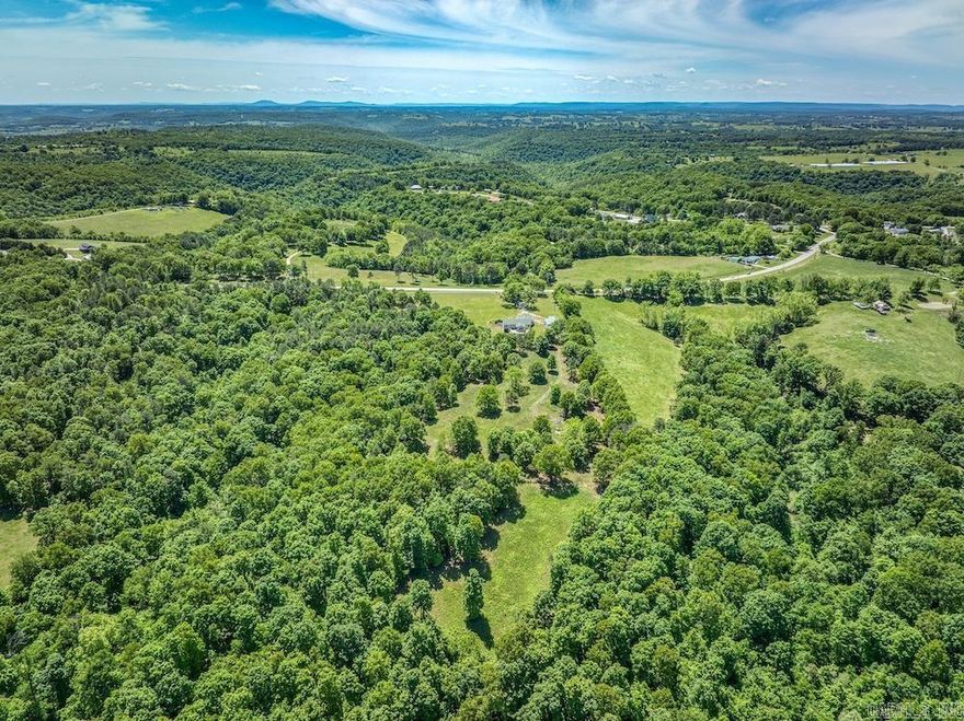 Beautiful 18± acre property just outside Omaha, Arkansas, featuring a stunning 2,272 sq ft custom home, quality improvements, and a perfect blend of pasture and timber. The home offers an open-concept layout with crown molding, custom trim, granite countertops, stainless steel appliances, custom cabinetry, an oversized laundry room, and a spacious master suite with a Jacuzzi tub, tile shower, and a large walk-in closet. A cozy sunroom with a fireplace and a recently built deck overlooks the scenic acreage. The property includes an oversized two-car garage, a heated and cooled 40x40 custom shop with office space and full bath, a 14x16 paint booth/shop, and multiple additional outbuildings. Mostly fenced with beautiful pasture, a loafing shed, and mature hardwood timber, this property is ideal for horses, livestock, hunting, or recreation. Located near Bull Shoals Lake, Table Rock Lake, and Branson, Missouri, this Boone County property offers peaceful Ozarks living with convenient access to recreation and amenities. A rare opportunity to own a move-in-ready custom home with productive acreage and exceptional improvements.