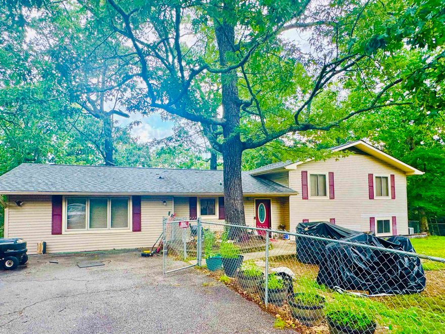 LARGE FAMILY 4 BEDROOM LAKE HOME!! GREAT AREA OF NICE HOMES WITH LOTS OF PRIVACY AND GREAT SETTING!! ITHAS 69 FT OF LAKE FRONTAGE GREAT FOR FISHING!! SKIIING!! KAYAKING OR JUST RELAXING IN THE SUN AND ENJOYINGTHE BEAUTIFUL VIEW!! The lake access is back aways down from the back of the home easily accessed. It also includes a storage shed on the lake front to store your fishing gear and kayaks! The walk to the lake has a beautiful woodsy trail. This home sits on a little over an acre and the yard is fully fenced around the home with two designated dog kennels. Has several double gates and small gates for better access. This is a family home and has plenty of room for the whole family to spread out and is great for entertaining. The master suite is very large with lots of great storage cabinets and closets. It also has a large garden tub and shower with light lavender colors. The kitchen is very functional with cabinets galore and granite countertops. The living room is large. The back deck has so many opportunities with screened in porch it does have some torn screens but not to hard to fix for someone with handy man skills. Sold "AS IS" Boat dock access. $ 50 a yr.