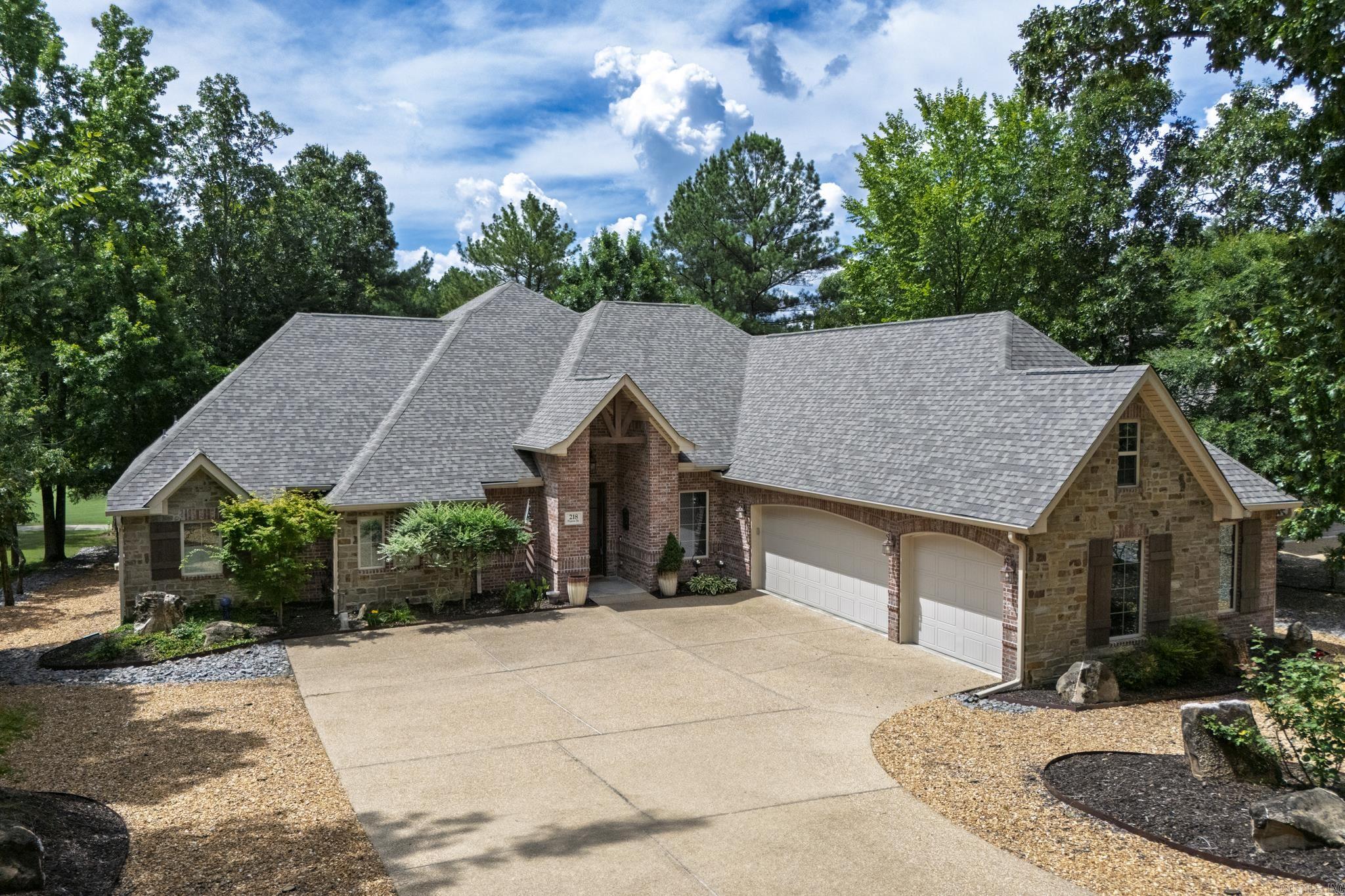 This "Maderas" floor plan with extra sq footage is located on the 6th fairway of Nina. You will find soaring ceilings and transom windows for breathtaking views. Large living room with gas fireplace opens to beautiful patio and fenced in yard for your fur babies. Formal dining room has space for everyone and a beautiful, recessed ceiling. Well-appointed kitchen has large island with breakfast bar, multi-level cabinetry, double convection ovens and a 5-burner gas range, granite countertops, extensive breakfast bar. Very nice office with French doors. Opulent Primary Suite with luxurious shower and tub has access to patio, extensive use of crown molding and trim. Two additional bedrooms on the opposite side of the home for privacy. Hardwood floors, accessible doorways, Marathon lifetime water heater, new roof in 2023. Stairway to attic. Low maintenance landscaping, three car garage. Professional photos coming soon Hot Springs Village boasts 9 golf courses, 11 lakes, pickleball, hiking trails, white sand beach, tennis, fitness center and much more. HSV has one time $2000 buy in for new residents.