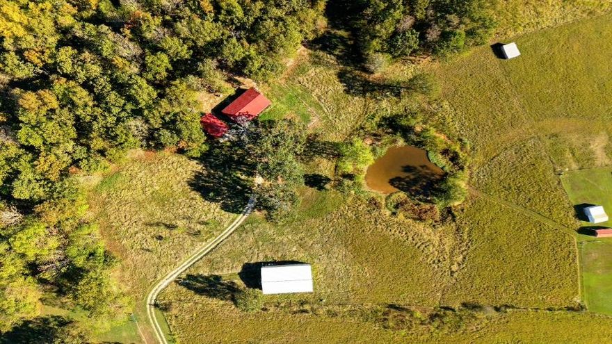 Discover 15 Acres of Pure Potential with this Property.  Nestled just off the highway, this secluded gem offers a serene mix of pasture, timber, and its own private STOCKED pond - ideal for peaceful living or future possibilities.   At the heart of the property sits a cozy 1,150 sq. ft.  home featuring 2 bedrooms and 2 baths, wrapped in a warm cabin-style ambiance. Whether you're starting fresh or looking for weekend retreat, it's ready to welcome you.  A covered carport keeps your vehicles sheltered, while the 30 x 60 shop building - complete with electricity - opens the door to hobbies, or business ventures.   Space to breathe, room to grow, and nature at your doorstep. Your dream escape awaits.