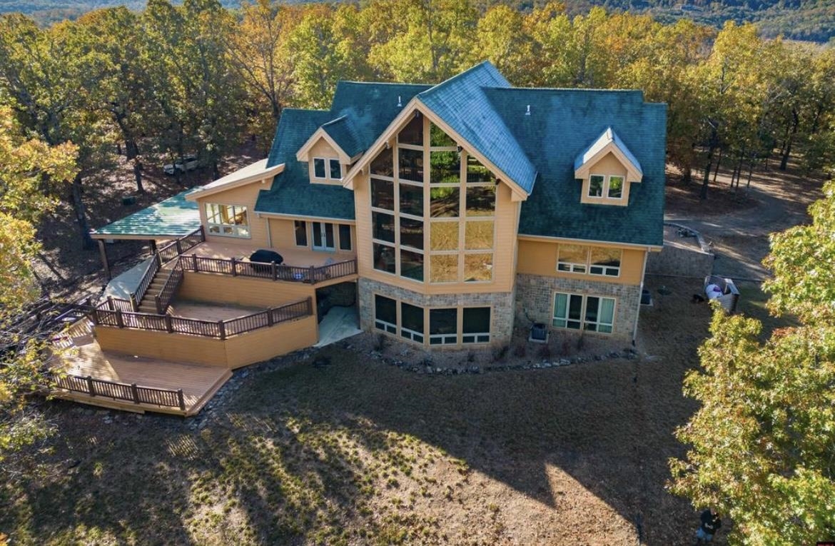 Gorgeous property all year around surrounded by Bulls Shoals Lake. This home provides plenty of living spaces with 6 large bedrooms and along with a large game room in the basement. Along with a very large living rom area that is open to the kitchen with the beautiful granite countertops. This home also provides a beautiful formal Dining Room with windows that surround the entire room giving you the feeling that you are out side while leaving you with plenary of room to have guest over for the holidays or any special occasion. This home also provides you with your own private boat dock to enjoy! This home is great to enjoy everything there is to do outdoors from hunting, fishing, kayaing or anything else that you want to do on the water!